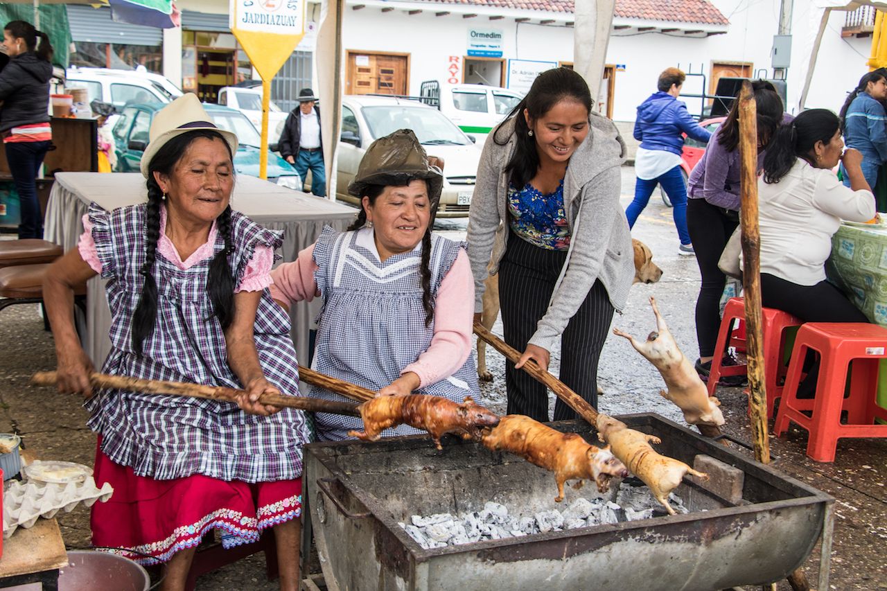 Peruvian-women-roasting-guinea-pigs-on-a-spit.jpg