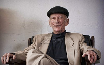 old-man-sitting-in-a-chair-smiling.jpg